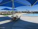 Community pool area with sunshades and chairs, splash pad in background at 34395 N Cherrystone Dr, San Tan Valley, AZ 85144