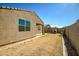 Backyard showcasing brick-lined edges, a covered patio, and stucco wall of the home's exterior at 36578 N Tatonga Trl, San Tan Valley, AZ 85140