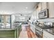 Bright, open kitchen featuring stainless steel appliances and a view of the living area at 36578 N Tatonga Trl, San Tan Valley, AZ 85140