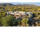 Stunning aerial view of a luxury estate with a pool, stone accents, and mountain views at 37870 N 98Th Pl, Scottsdale, AZ 85262