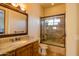 Bright bathroom featuring a wood vanity with marble countertop and a shower-tub combo at 37870 N 98Th Pl, Scottsdale, AZ 85262