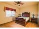 Bedroom featuring a decorative wood frame bed, side tables, and carpeted flooring at 37870 N 98Th Pl, Scottsdale, AZ 85262