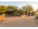 Expansive home showcasing a stone facade, mature trees, and a brick driveway leading to a multi-car garage at 37870 N 98Th Pl, Scottsdale, AZ 85262