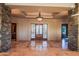 Grand foyer with stone pillars, decorative chandelier, and detailed marble flooring, creating a luxurious entrance at 37870 N 98Th Pl, Scottsdale, AZ 85262