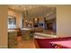 Bright game room featuring a pool table, bar area with stone accents, and views of the outdoors at 37870 N 98Th Pl, Scottsdale, AZ 85262
