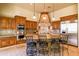 Spacious kitchen features a central island with seating and granite countertops at 37870 N 98Th Pl, Scottsdale, AZ 85262