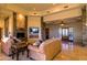 Open-concept living area with a stone fireplace, comfortable seating, and access to the outdoors at 37870 N 98Th Pl, Scottsdale, AZ 85262
