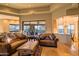 Spacious living room featuring a large window with picturesque views, comfortable seating, and stylish decor at 37870 N 98Th Pl, Scottsdale, AZ 85262