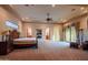 Expansive main bedroom boasts fireplace, tray ceiling and doors to patio at 37870 N 98Th Pl, Scottsdale, AZ 85262