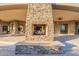 Inviting outdoor stone fireplace providing warmth and ambiance to a large patio at 37870 N 98Th Pl, Scottsdale, AZ 85262