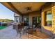 Outdoor dining and kitchen space with a covered patio and stone finishes at 37870 N 98Th Pl, Scottsdale, AZ 85262