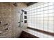 Tiled shower with glass block window and built in shelves at 37870 N 98Th Pl, Scottsdale, AZ 85262