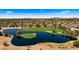 Picturesque aerial view of a lush golf course community, featuring a tranquil lake and meticulously maintained greens at 3882 E Andalusia Ave, Gilbert, AZ 85298