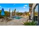 Resort-style backyard features a pool, pergola with outdoor kitchen, and elegant landscaping at 3882 E Andalusia Ave, Gilbert, AZ 85298