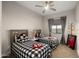 Charming bedroom features two twin beds, ceiling fan and a window that provides natural light at 3882 E Andalusia Ave, Gilbert, AZ 85298