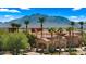 Elegant clubhouse with porte-cochere entrance, surrounded by lush landscaping and framed by majestic mountain views at 3882 E Andalusia Ave, Gilbert, AZ 85298
