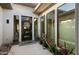 Welcoming front entrance with a decorative door, potted plants, and accent lanterns at 3882 E Andalusia Ave, Gilbert, AZ 85298