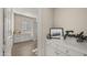 Hallway featuring a view into the laundry room with counter space and white cabinets at 3882 E Andalusia Ave, Gilbert, AZ 85298