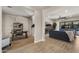 Spacious living area with wood-look floors, a comfortable sofa, and an adjacent office space at 3882 E Andalusia Ave, Gilbert, AZ 85298