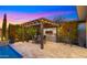 Charming outdoor kitchen under a pergola with string lights, offering a perfect blend of ambiance and functionality at 3882 E Andalusia Ave, Gilbert, AZ 85298