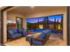 Stylish covered patio with comfortable seating, a mounted TV, and serene views of the sparkling pool and landscaped backyard at 3882 E Andalusia Ave, Gilbert, AZ 85298