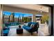 Covered patio featuring a sofa and views of the pool, water feature, outdoor kitchen, and desert landscaping at 3882 E Andalusia Ave, Gilbert, AZ 85298