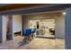 Inviting outdoor patio with a cozy fireplace and seamless access to the modern kitchen through sliding glass doors at 3882 E Andalusia Ave, Gilbert, AZ 85298