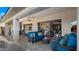 Spacious covered patio with stylish seating, a ceiling fan, and access to indoor living spaces at 3882 E Andalusia Ave, Gilbert, AZ 85298