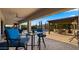 Outdoor patio with seating and a view of the pool, landscaping, and outdoor kitchen under a pergola at 3882 E Andalusia Ave, Gilbert, AZ 85298