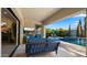 Outdoor patio with a sofa and views of the pool, water feature, and lounge chairs for relaxing at 3882 E Andalusia Ave, Gilbert, AZ 85298