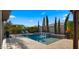 Beautiful backyard pool with water feature, lounge chairs and lush landscaping at 3882 E Andalusia Ave, Gilbert, AZ 85298