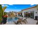 This backyard oasis features a sparkling pool, patio space, outdoor kitchen, and lounge chairs perfect for relaxation at 3882 E Andalusia Ave, Gilbert, AZ 85298