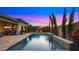 Backyard pool with water feature, lounge chairs, and an outdoor kitchen at 3882 E Andalusia Ave, Gilbert, AZ 85298