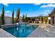 Incredible pool with water feature, patio kitchen, and mature landscaping at 3882 E Andalusia Ave, Gilbert, AZ 85298