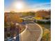 Inviting gated entrance leading to a well-manicured community with mature trees and stunning mountain views at 3882 E Andalusia Ave, Gilbert, AZ 85298