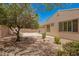 Well maintained backyard with mature tree, landscaping and access to covered back patio at 4286 E Buckboard Rd, Gilbert, AZ 85297