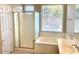 Bright bathroom featuring a shower, tub, and updated fixtures, perfect for relaxation at 4286 E Buckboard Rd, Gilbert, AZ 85297