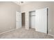 Neutral carpeted bedroom with a ceiling fan, closet, and doors to other areas at 4286 E Buckboard Rd, Gilbert, AZ 85297