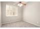 Minimalist bedroom with ceiling fan, window with blinds, and neutral carpet at 4286 E Buckboard Rd, Gilbert, AZ 85297