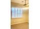 A cozy bedroom featuring plantation shutters and a ceiling fan at 4286 E Buckboard Rd, Gilbert, AZ 85297