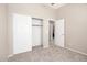 Neutral carpeted bedroom featuring a closet and access to other rooms at 4286 E Buckboard Rd, Gilbert, AZ 85297