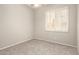 Cozy bedroom with window shutters, ceiling fan, and neutral carpeting at 4286 E Buckboard Rd, Gilbert, AZ 85297