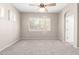 Inviting bedroom with plush carpeting, a ceiling fan, and large window providing natural lighting at 4286 E Buckboard Rd, Gilbert, AZ 85297