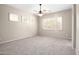 Bright bedroom featuring carpeted flooring, multiple windows, and a ceiling fan for added comfort at 4286 E Buckboard Rd, Gilbert, AZ 85297