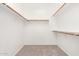 Walk in closet features wood shelving and neutral carpet at 4286 E Buckboard Rd, Gilbert, AZ 85297
