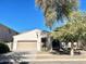 Single-story home with two car garage and shade tree in the front yard at 4286 E Buckboard Rd, Gilbert, AZ 85297