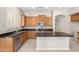 Well-lit kitchen featuring oak cabinets, granite countertops, stainless steel appliances, and a central island at 4286 E Buckboard Rd, Gilbert, AZ 85297
