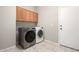 Modern laundry room with front-load washer and dryer and built-in cabinets at 4286 E Buckboard Rd, Gilbert, AZ 85297