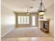 Bright living room with large windows, a fireplace, and ample space for various activities and furniture at 4286 E Buckboard Rd, Gilbert, AZ 85297