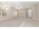 Bright, open living area with plush carpeting, tile entryway, ceiling fans, and natural light at 4286 E Buckboard Rd, Gilbert, AZ 85297
